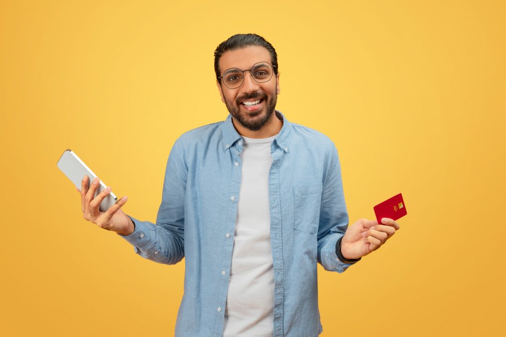 Man with smartphone and credit card